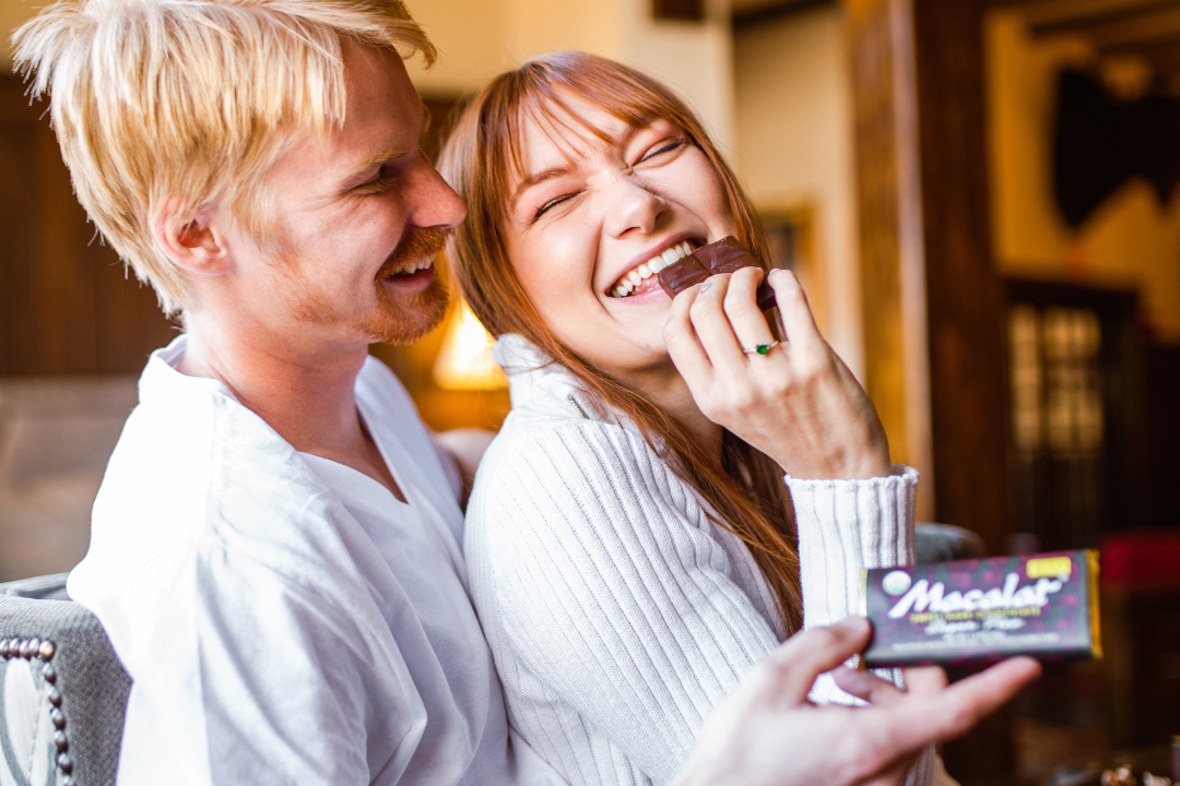 Happy couple sharing a Macalat Sweet Dark Chocolate Bar